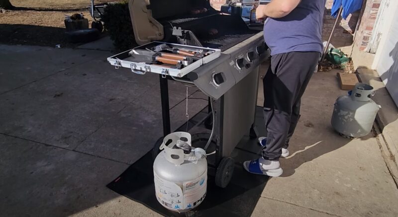 man grilling meat